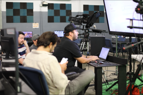 Students learning video production at JDS Creative Academy using professional cameras and editing software